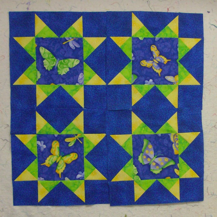 Four quilt blocks together of the Arm Star Quilt Block.