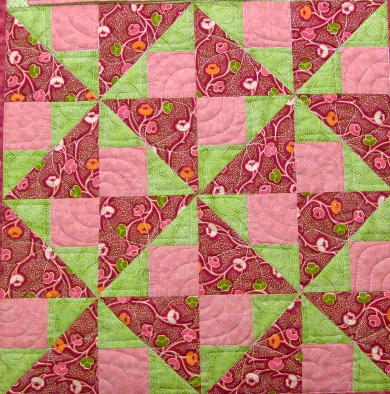 Spinner quilt blocks sewn together.