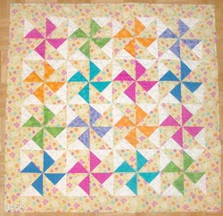 Baby quilt, double pinwheel quilt block.
