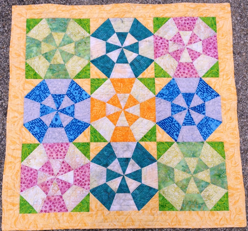 Handmade batik baby quilt from http://www.homesewnbycarolyn.com