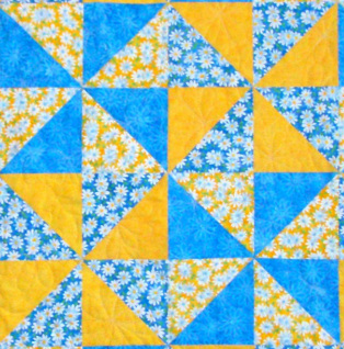 Four pinwheel quilt blocks sewn together.