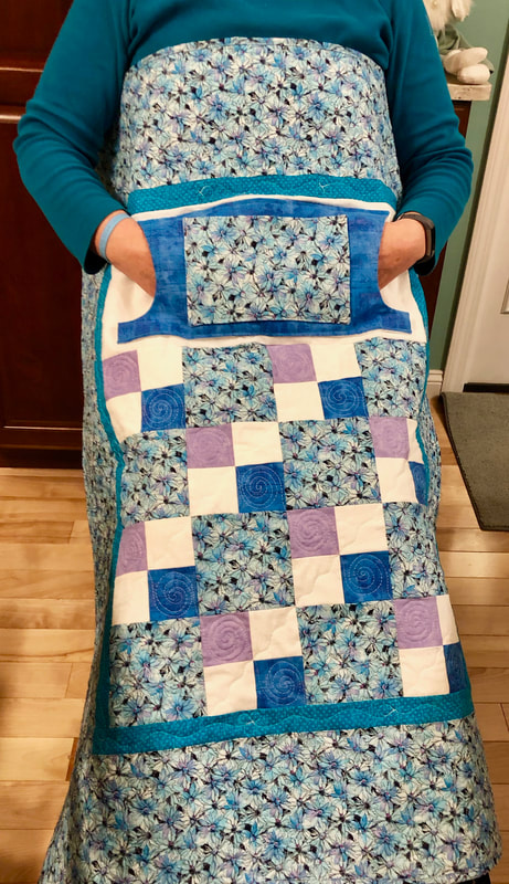 Blue Daisy Lovie Lap Quilt with Pockets for sale from http://www.HomeSewnByCarolyn.com 