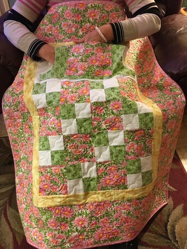 Pink Daisy Lovie Lap Quilt with Pockets from http://www.HomeSewnByCarolyn.com