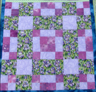 Four quilt blocks from thrifty quilt pattern.