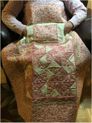 Delicate Pinwheels Lovie Lap Quilt with Pockets from http://www.homesewnbycarolyn.com