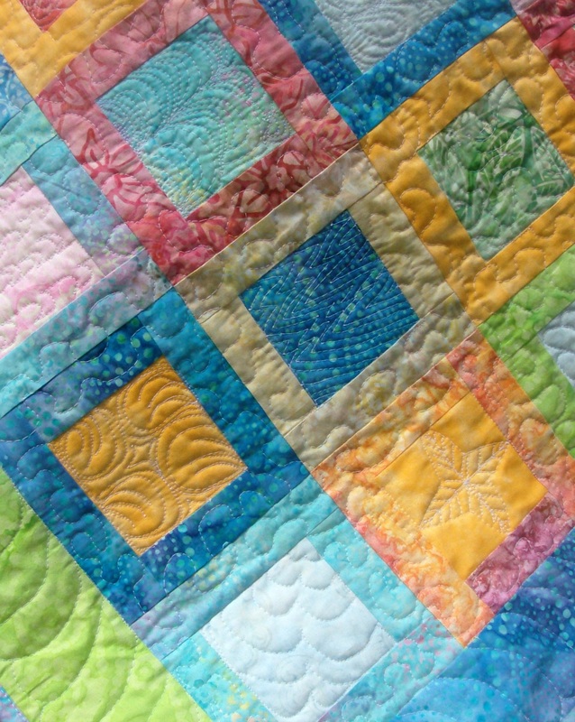 Batik Baby Quilt with free motion quilting designs.  Each block has a unique free motion quilting pattern.