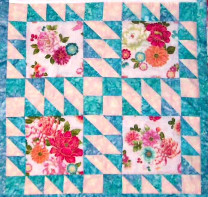 Four blocks sewn together of the quilt block, Double Sawtooth.
