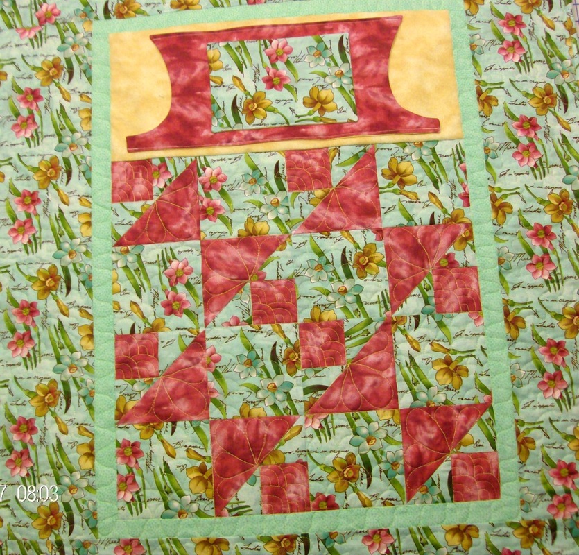 Lovie Lap quilt with pockets, spool and bobbin quilt block.