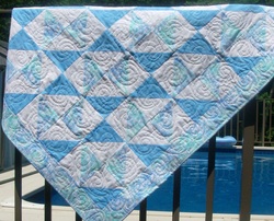 I have free motion quilted spirals throughout this sweet boy baby quilt.