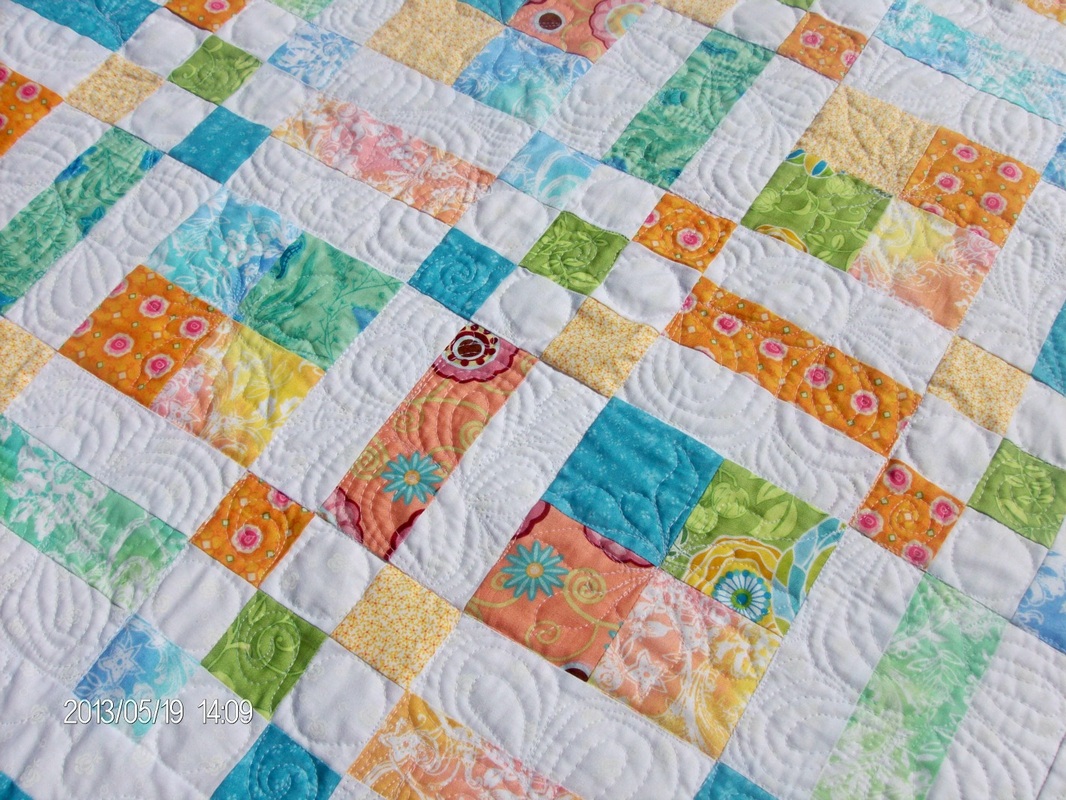 Patches Baby Quilt.  I love the softness of this quilt.  There is beautiful free motion quilting designs throughout.