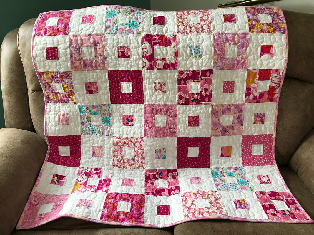Pink and White Baby Quilt for sale from http://www.HomeSewnByCarolyn.com