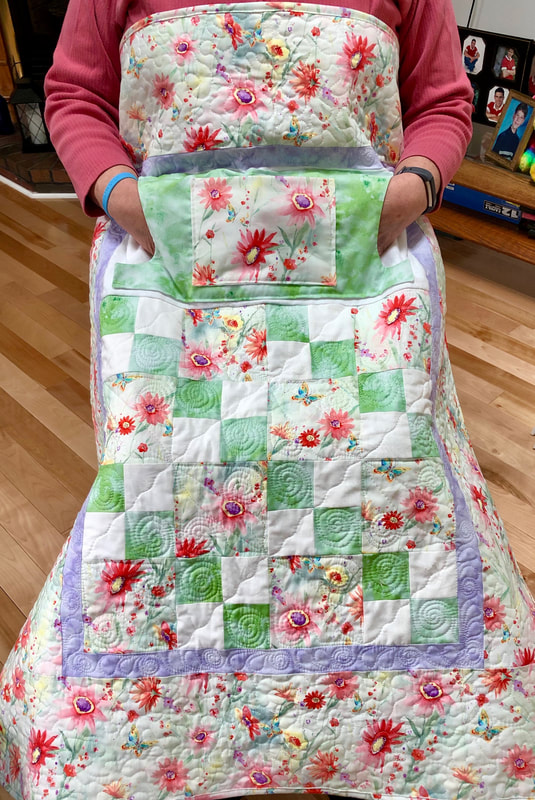 Pastel Daisy Lovie Lap Quilt with Pockets, wheelchair quilt for sale from http://www.HomeSewnByCarolyn.com/lovie-lap-quilts.html
