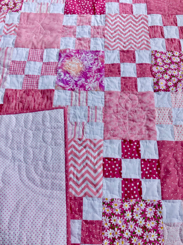 Pink and White Scrappy Nine Patch Baby Quilt for sale from http://www.HomeSewnByCarolyn.com/baby-quilts.html