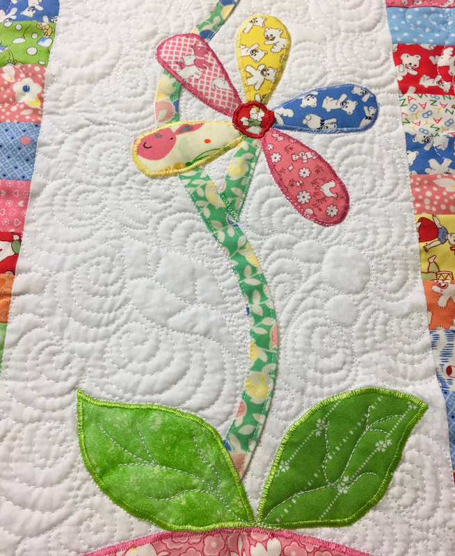 Free motion quilting on floral 1930's Baby Quilt from http://www.HomeSewnByCarolyn.com