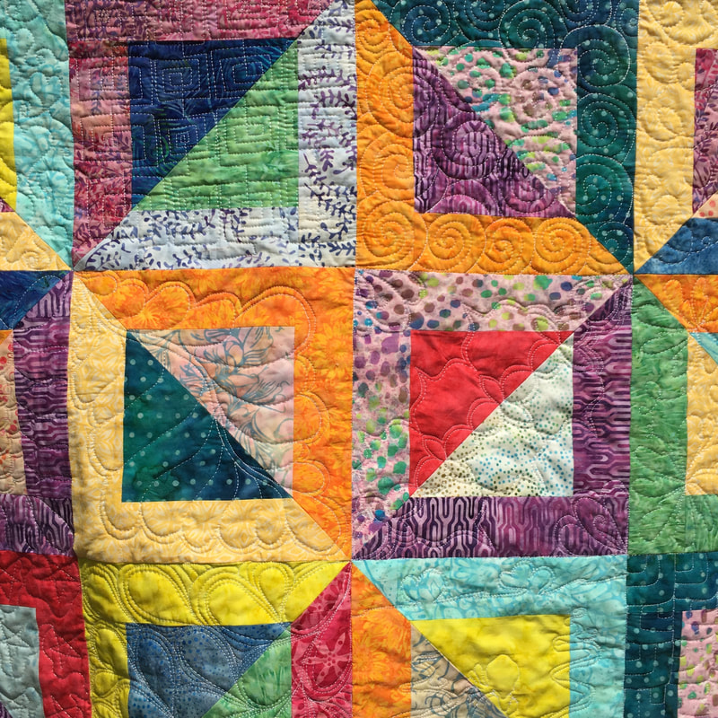 Free motion quilting on batik baby quilt from http://www.HomeSewnByCarolyn.com