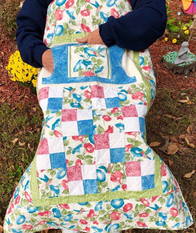 Morning Glory Lovie Lap Quilt with Pockets for sale from http://www.HomeSewnByCarolyn.com/lovie-lap-quilts.html  