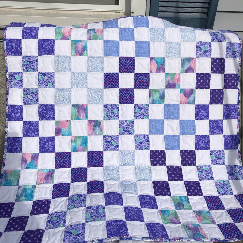 Shades of Purple Baby Quilt is made with the nine patch quilt block.  This is a very pretty quilt that will make a great gift for that new baby.  