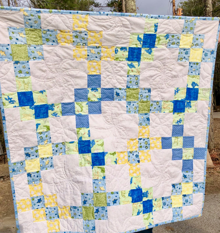 Blue, Green and Yellow Baby Quilt done in the Garlic Knot quilt block. 