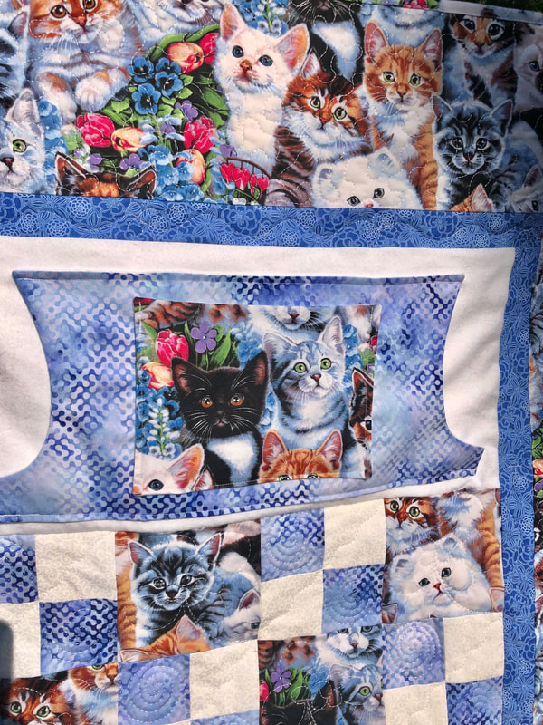 Kitten Lovie Lap Quilt with Pockets to keep your hands warm and a second pocket for small items.
