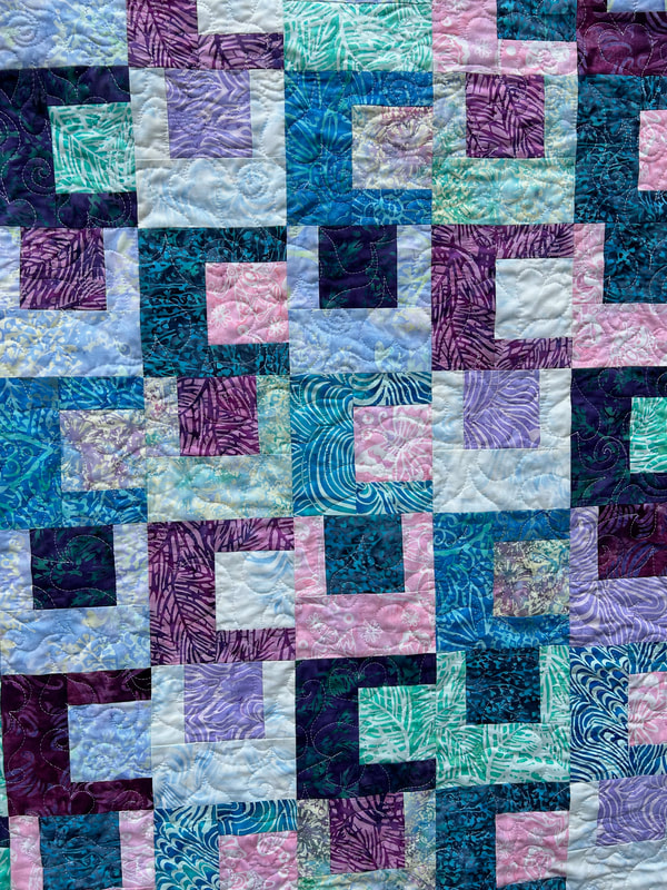 Batik Blocks Baby Quilt in teal, pink, purple and blue.