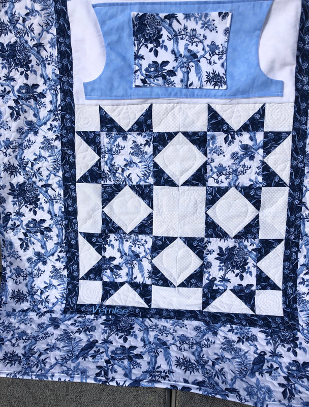 Blue and White Wheelchair lap quilt with pockets to keep your hands warm.