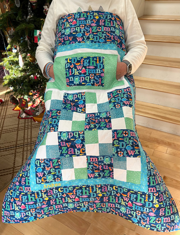 Alphabet Lovie Lap quilt with pockets lined in flannel.