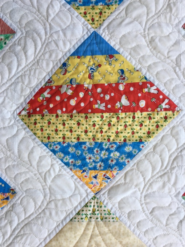 Free motion quilting on Scrap Quilt from http://www.HomeSewnByCarolyn.com